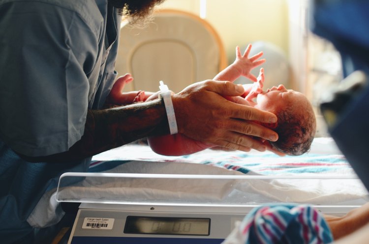 nurse holding a new born