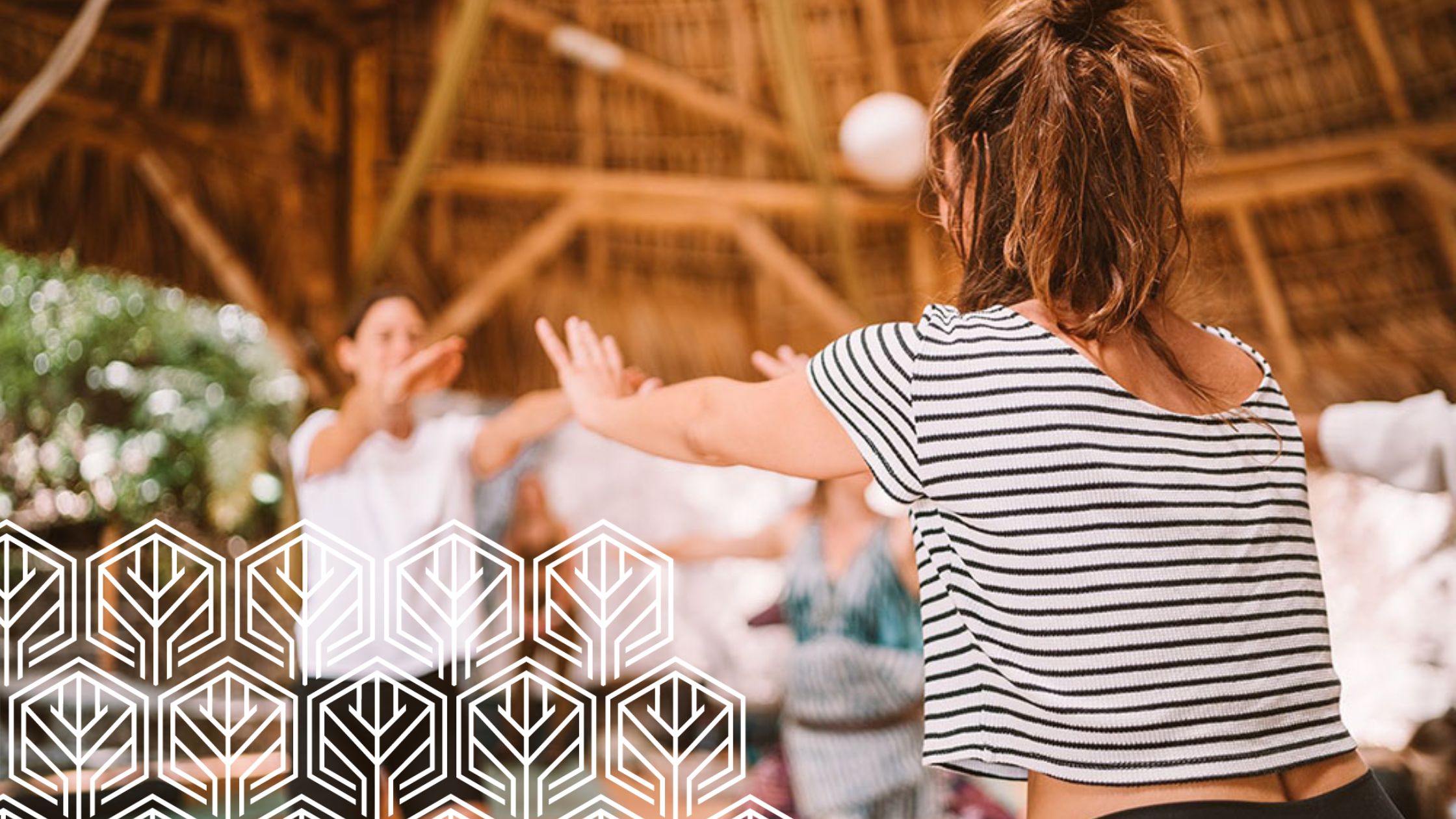 yoga student facing back in her stripped shirt