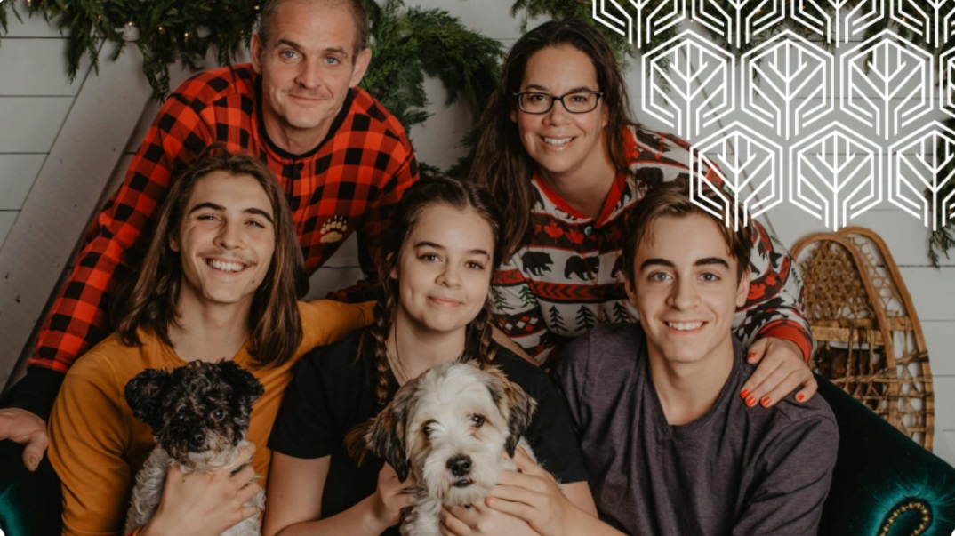image of a family with two pet dogs